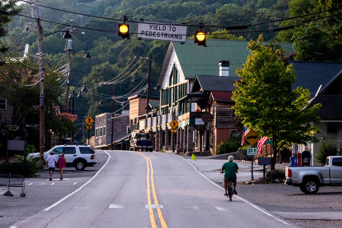 A cyclist rides down Main Street in the village of Chimney Rock.