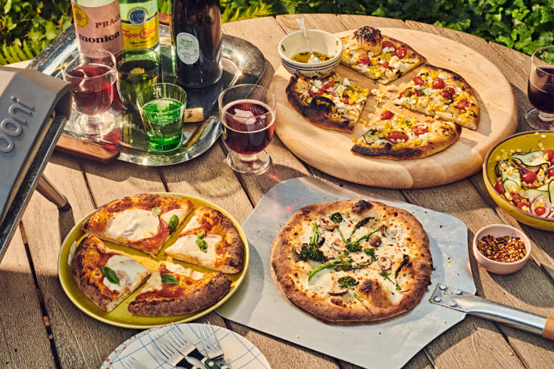 multiple pizzas on a table