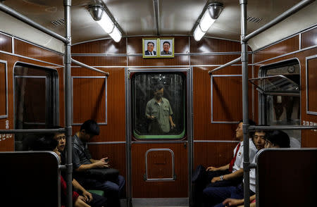 Portraits of late North Korean leaders Kim Il Sung and Kim Jong Il are seen on a train as it leaves a subway station in Pyongyang, North Korea, September 11, 2018. REUTERS/Danish Siddiqui