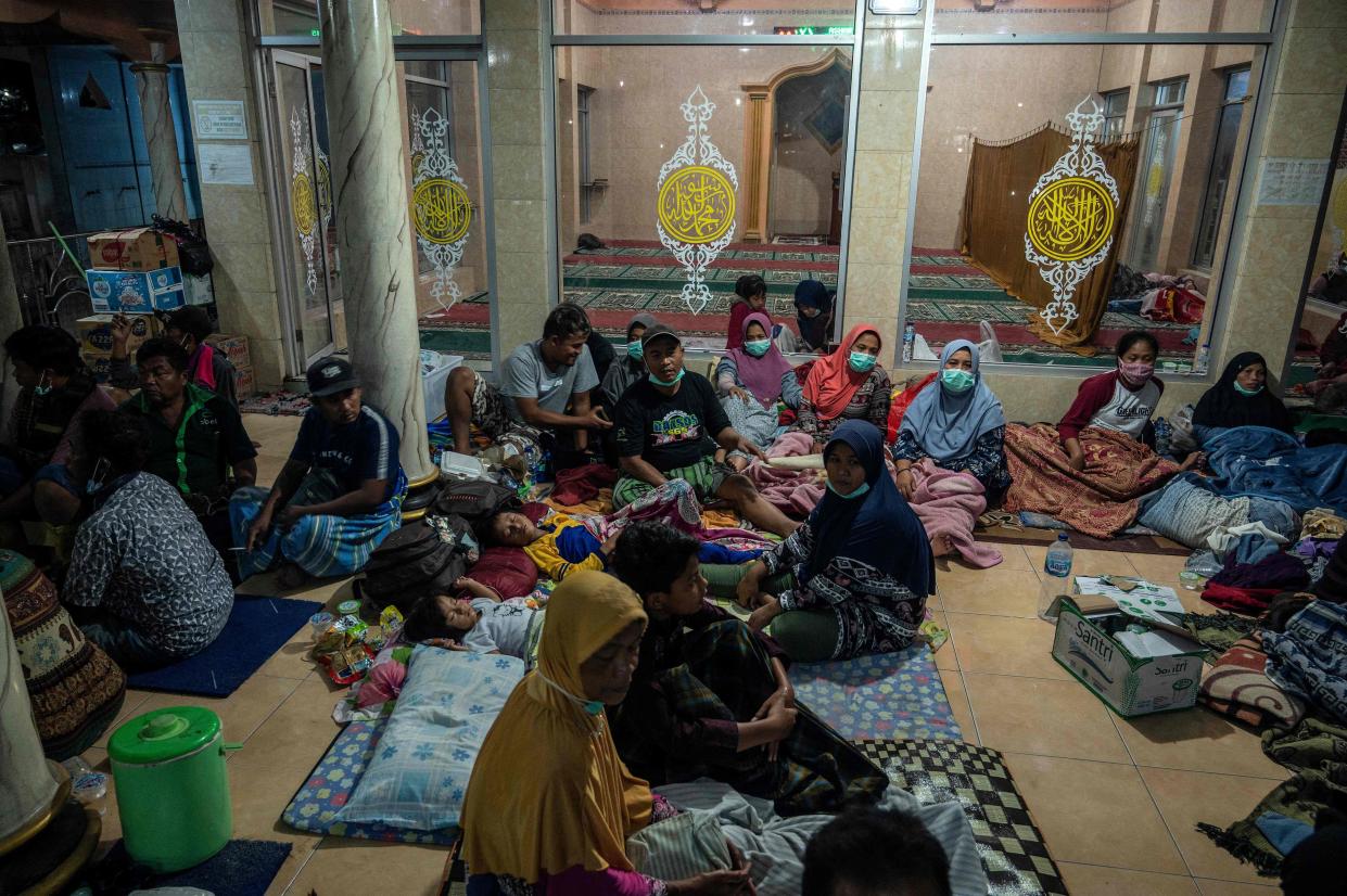 Evacuees take shelter at the local mosque of Sumber Wuluh village, in Lumajang.