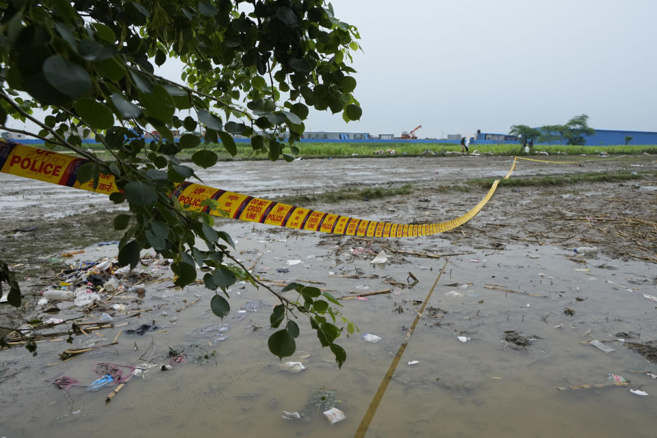 Police tape cordons off the scene a day after a fatal stampede, in Fulrai village of Hathras district, Uttar Pradesh, India, Wednesday, July 3, 2024. Thousands of people at a religious gathering rushed to leave a makeshift tent, setting off a stampede Tuesday that killed more than hundred people and injured scores. (AP Photo/Rajesh Kumar Singh)