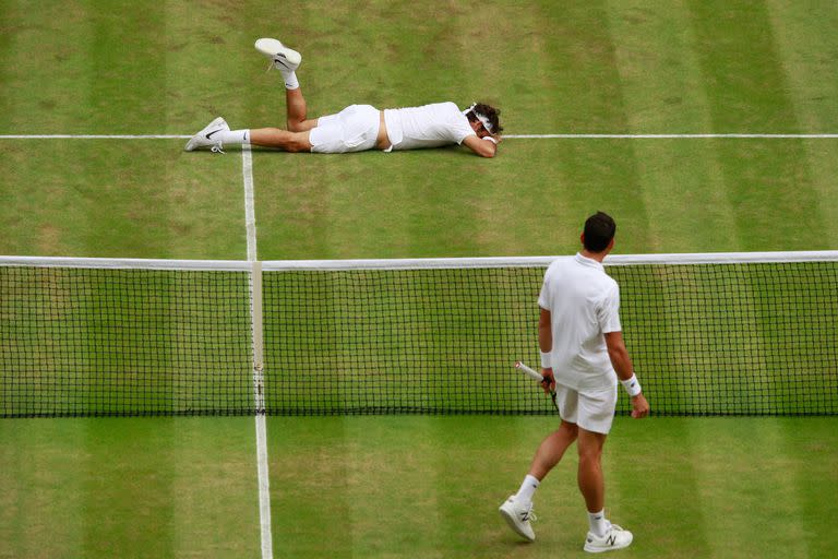 Una situación inusual: Federer, caído sobre el césped de Wimbledon, en las semifinales de 2016 ante Raonic. Sufrió problemas en la rodilla izquierda y luego se bajó de los JJOO de Río.