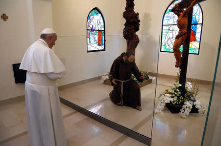 Pope Francis prays inside the San Francesco chapel in Pietrelcina, Italy March 17, 2018. REUTERS/Ciro De Luca