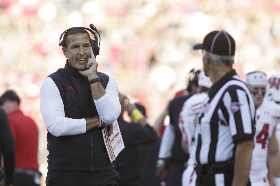 Wisconsin head coach Luke Fickell, left, speaks with an official during the first half of an NCAA college football game against Washington State, Saturday, Sept. 9, 2023, in Pullman, Wash. (AP Photo/Young Kwak)