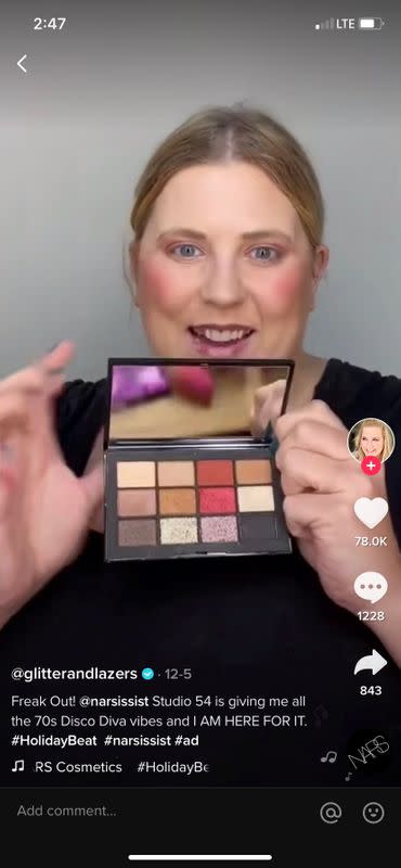 A screengrab shows a video of TikTok creator @glitterandlazers taking part in a holiday marketing campaign on TikTok for beauty brand NARS Cosmetics