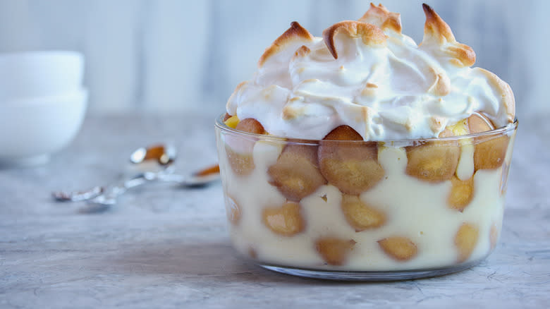 banana pudding with meringue in glass dish