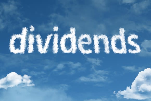 Written in skywriting, the word dividends is set in a partly cloudy sky.