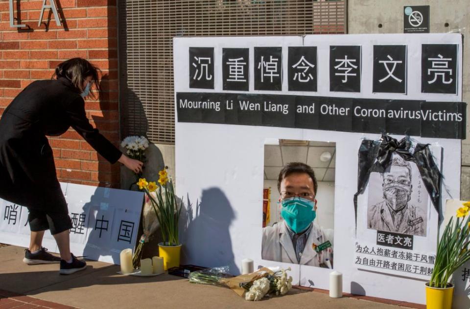 Chinese students and their supporters hold a memorial for Dr Li Wenliang, who was the whistleblower of the Coronavirus, Covid-19, that originated in Wuhan, China outside the UCLA campus in Westwood, California, on February 15, 2020. (Photo by Mark RALSTON / AFP) (Photo by MARK RALSTON/AFP via Getty Images)