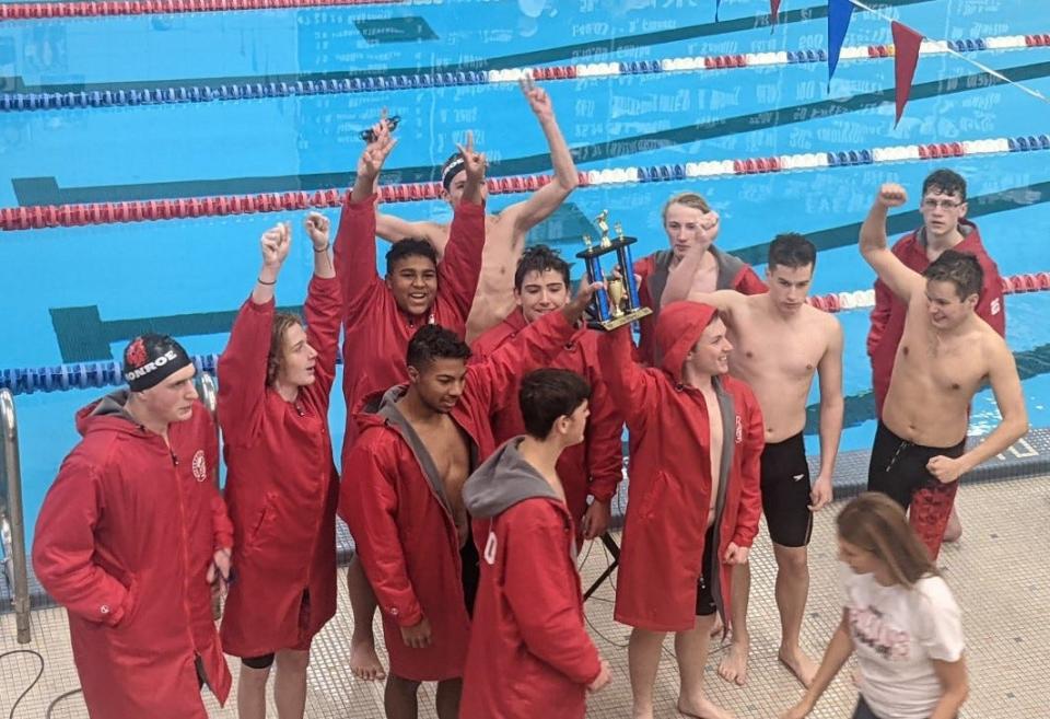 Monroe's boys swimming team celebrates with its seecond-place trophy at the Wayne Invitational Saturday.
