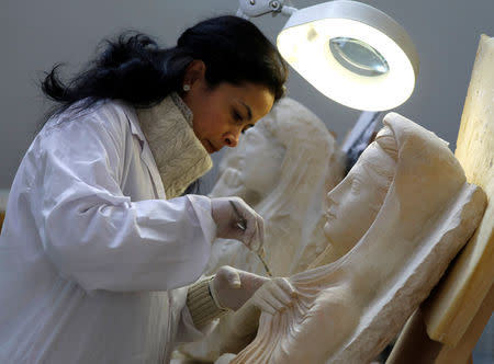 A specialist works on a damaged statue from Palmyra at Syria's National Museum of Damascus, Syria January 9, 2019. Picture taken January 9, 2019. REUTERS/Omar Sanadiki