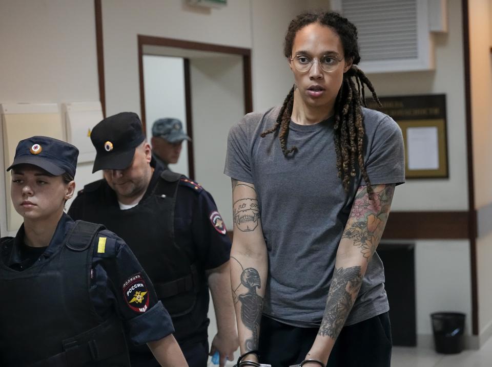 WNBA star and two-time Olympic gold medalist Brittney Griner is escorted from a court room ater a hearing, in Khimki just outside Moscow, Russia, Thursday, Aug. 4, 2022. A judge in Russia has convicted American basketball star Brittney Griner of drug possession and smuggling and sentenced her to nine years in prison. (AP Photo/Alexander Zemlianichenko)