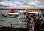 <p>Chinese tourists disembark from a boat on the Yalu river near the border city of Dandong, Liaoning province, northern China across from the city of Sinuiju, North Korea on May 23, 2017 in Dandong, China. (Photo: Kevin Frayer/Getty Images) </p>