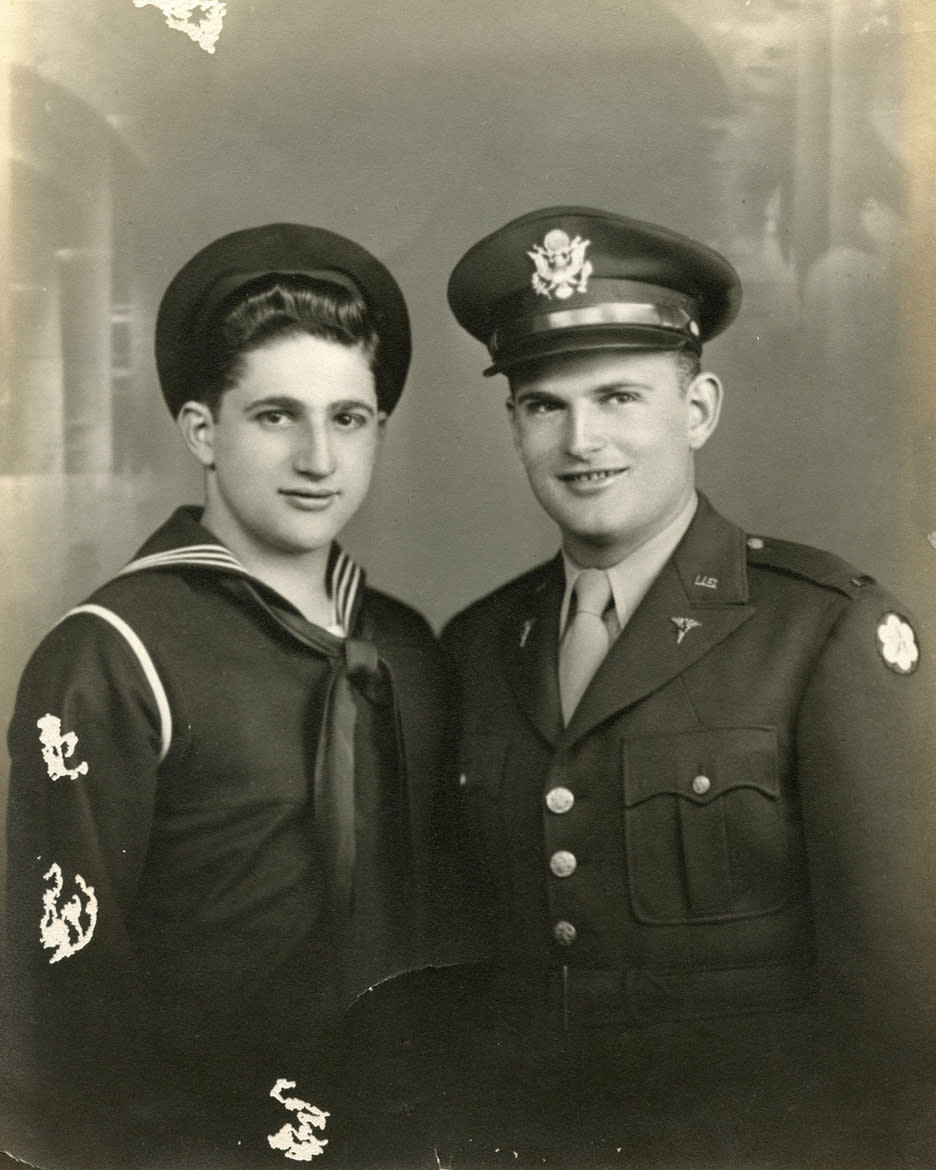 This November 1943 photo provided by his family shows shows Robert Fleury, left, and his brother Ed in their military uniforms. Robert served in World War II and parlayed the skills he learned in the war into a decades-long career with the National Weather Service. He died of complications from the COVID-19 coronavirus at a veteran's home in Scarborough in his longtime home state of Maine at the age of 94 on April 21, 2020. (Family photo via AP)