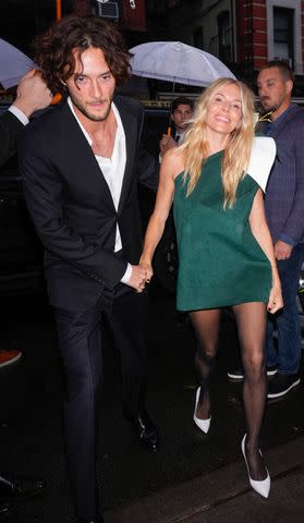 <p>Gotham/GC Images</p> Oli Green and Sienna Miller attend Anna Wintour's pre-Met Gala dinner in New York City.