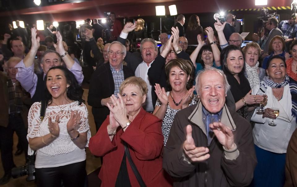 Quebec Liberal party supporters react as they watch the results on election night, Monday, April 7, 2014, in Saint-Felicien, Quebec. The Liberal Party won Quebec's legislative elections Monday, in a crushing defeat for the main separatist party and major setback for the cause of independence in the French-speaking province. (AP Photo/The Canadian Press, Clement Allard)