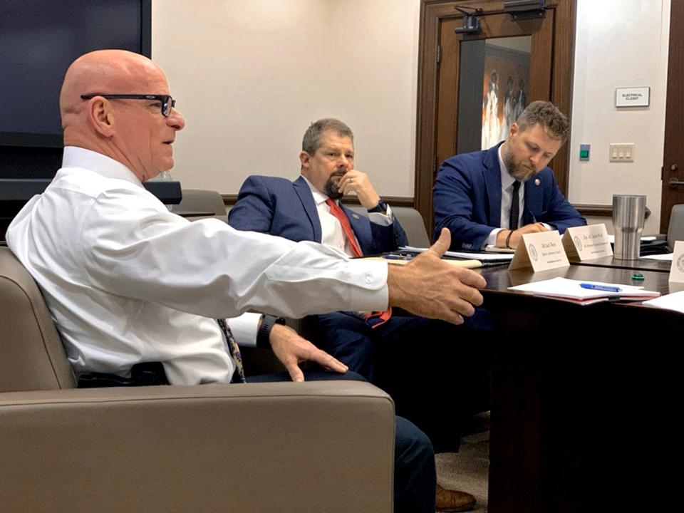 Oklahoma Public Safety Commissioner Tim Tipton, left, speaks during a One Oklahoma Task Force meeting on March 11, as District 27 District Attorney Jack Thorp and Deputy Attorney General Justin Wolf listen.  The task force was launched by Gov. Kevin Stitt to discuss law enforcement issues and solutions for tribal reservations.