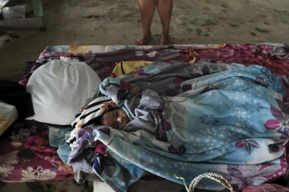 A baby sleeps in a makeshift shelter during the passage of Hurricane Iota in Siuna, Nicaragua, Tuesday, Nov. 17, 2020. Hurricane Iota tore across Nicaragua on Tuesday, hours after roaring ashore as a Category 4 storm along almost exactly the same stretch of the Caribbean coast that was recently devastated by an equally powerful hurricane. (AP Photo/Carlos Herrera)