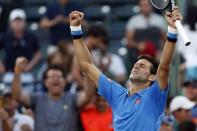 Mar 31, 2015; Key Biscayne, FL, USA; Novak Djokovic celebrates after his match against Alexandr Dolgopolov (not pictured) on day nine of the Miami Open at Crandon Park Tennis Center. Djokovic won 6-7 (3), 7-5, 6-0. Mandatory Credit: Geoff Burke-USA TODAY