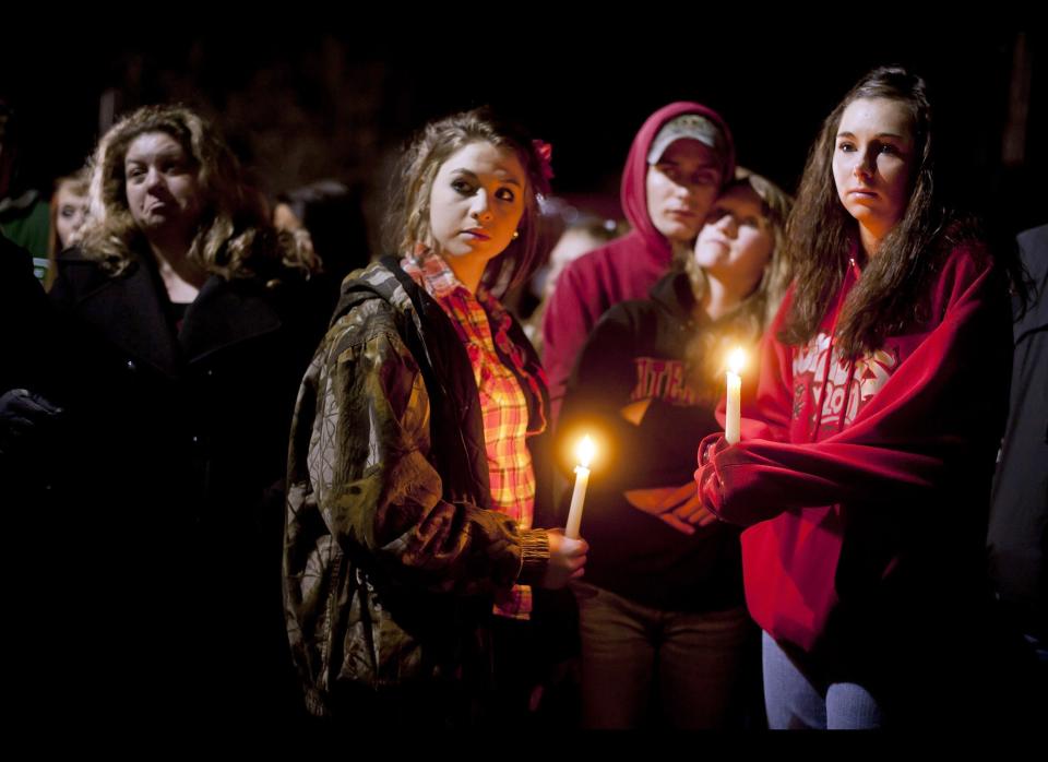 Students and those in the community embrace one another as they hold a candlelight vigil at St Mary's of the Assumption Church in Chardon, Ohio on Feb. 28, 2012. 