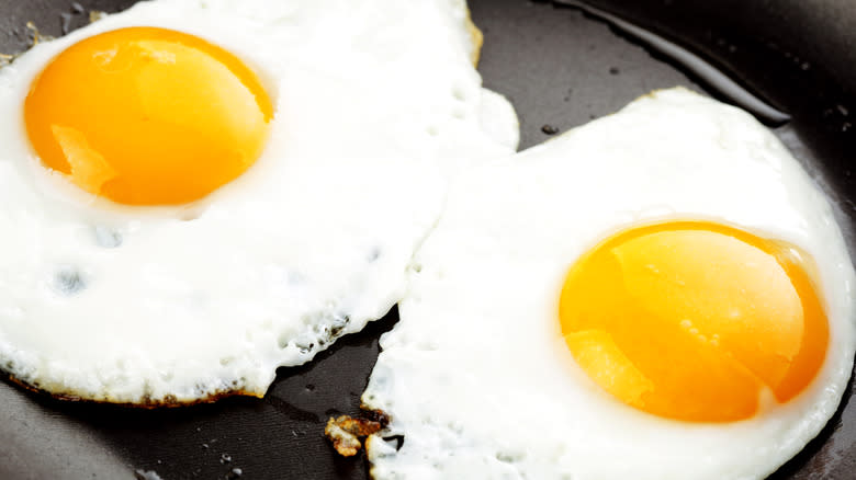 Two fried eggs in pan