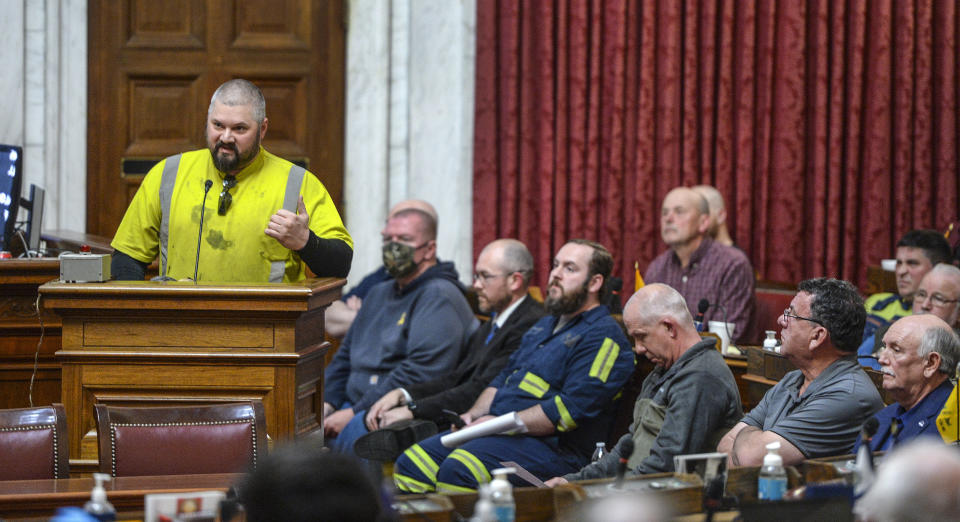 West Virginia coal miner Jesse Stolzenfels speaks at a public hearing against a bill that would have stripped regulatory authority from the state office of miners' health, safety and training in the House of Delegates chamber in state Capitol on Monday, February 28, 2022 in Charleston W.Va. (Kenny Kemp/Charleston Gazette-Mail via AP)