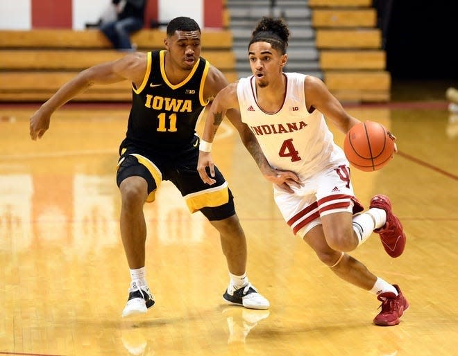 Khristian Lander (4), dribbling against Iowa, graduated early from Reitz High School so he could join the Indiana Hoosiers.