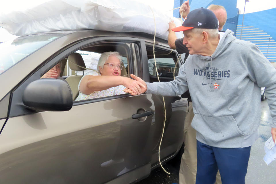 Jim "Mattress Mack" McIngvale, of Houston, shakes hands with a woman he had just given a free mattress in Atlantic City N.J., Tuesday, Nov. 1, 2022. A prolific gambler with a knack for attention-getting bets stands to win nearly $75 million if the Houston Astros win the World Series, including what sports books say would be the largest payout on a single legal sports bet in U.S. history. McIngvale has wagered a total of $10 million with numerous sports books on an Astros victory. (AP Photo/Wayne Parry)