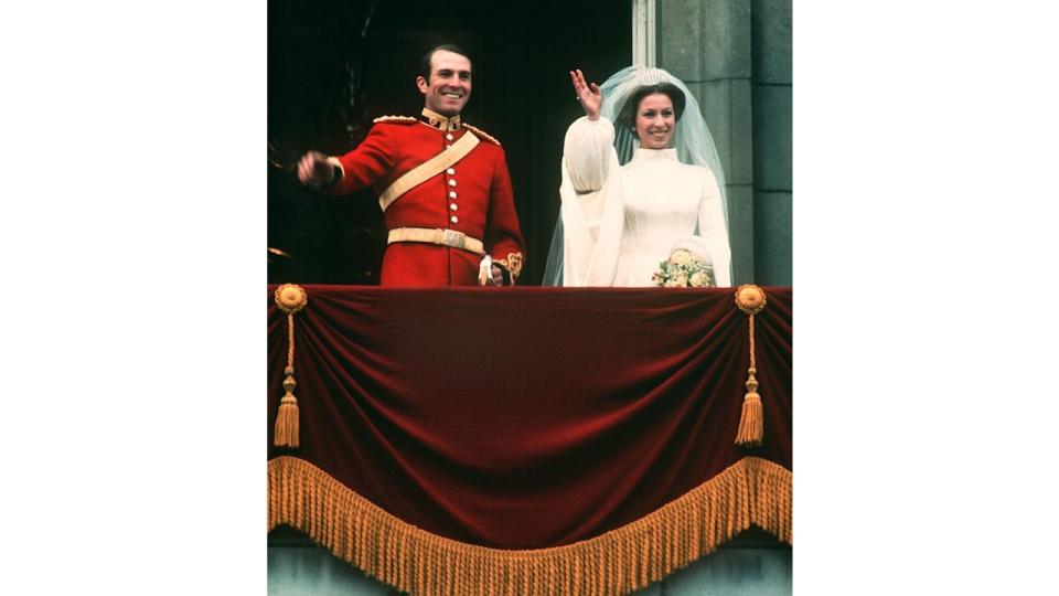 Captain Mark Phillips and Princess Anne wave from palace balcony on wedding day