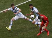 Belgium's Kevin Mirallas (R) heads the ball past Argentina's Jose Basanta (L) and Ezequiel Garay during their 2014 World Cup quarter-finals at the Brasilia national stadium in Brasilia July 5, 2014. REUTERS/David Gray