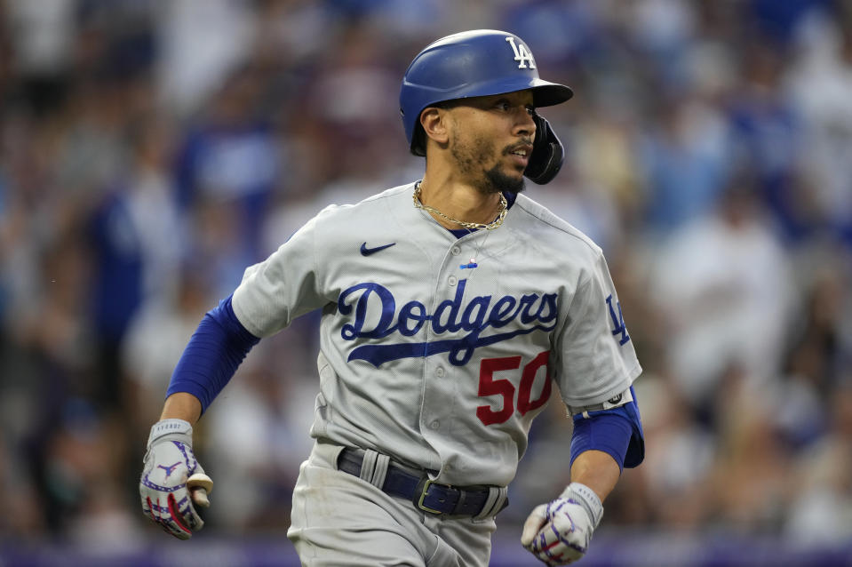 Los Angeles Dodgers' Mookie Betts watches his double off Colorado Rockies relief pitcher Mychal Givens during the seventh inning of a baseball game Saturday, July 17, 2021, in Denver. (AP Photo/David Zalubowski)