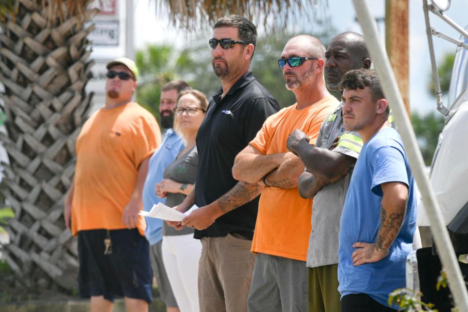 People gather on the side of John Sims Parkway in Niceville Tuesday to watch as a funeral procession for former Niceville Fire Chief Michael Wright passes by Tuesday afternoon.