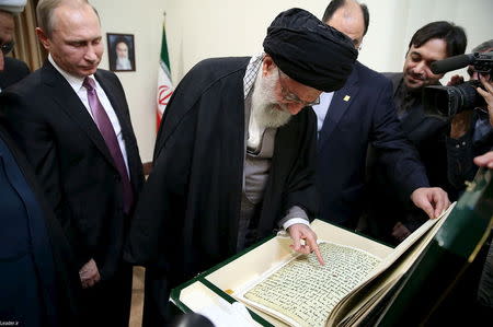 Iran's Supreme Leader Ayatollah Ali Khamenei (C) receives a gift from Russia's President Vladimir Putin (L) in Tehran November 23, 2015. REUTERS/leader.ir/Handout via Reuters