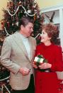 <p>Although Nancy Regan decorated the Blue Room tree as well, the Reagans pose here in front of a more casual tree in the White House living quarters. </p>