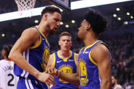 Klay Thompson #11 and Quinn Cook #4 of the Golden State Warriors celebrate the play against the Toronto Raptors in the second quarter during Game One of the 2019 NBA Finals at Scotiabank Arena on May 30, 2019 in Toronto, Canada. (Photo by Gregory Shamus/Getty Images)