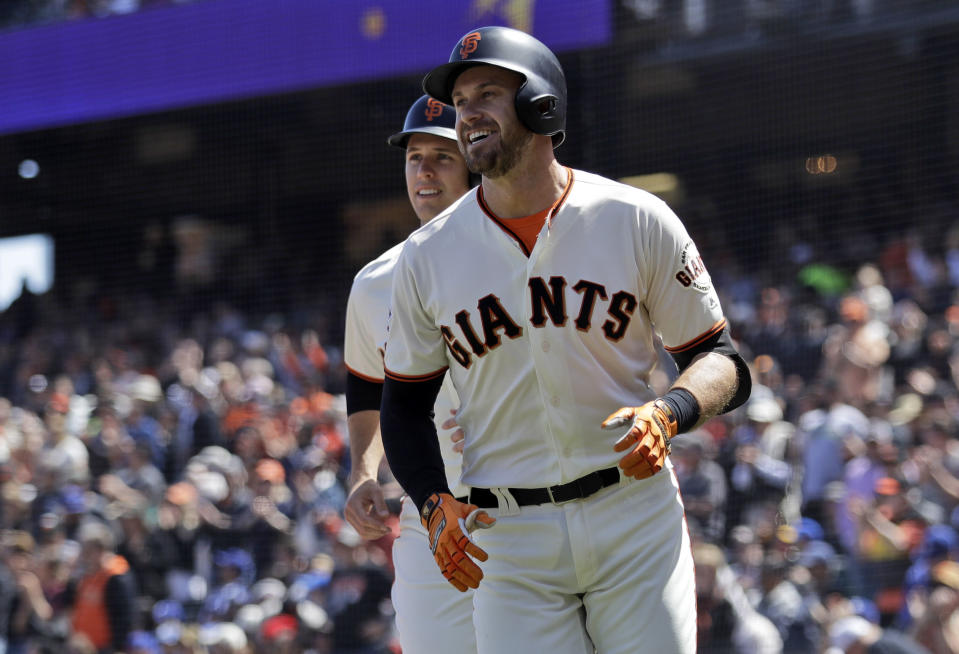 San Francisco Giants’ Evan Longoria, right, smiles in front of teammate Buster Posey after Longoria’s three-run home run during the first inning of a baseball game against the Los Angeles Dodgers Sunday, April 29, 2018, in San Francisco. (AP Photo/Marcio Jose Sanchez)