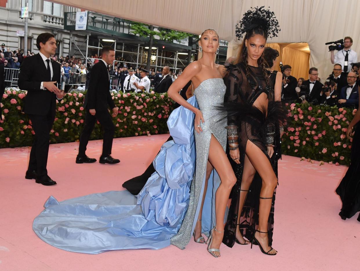 Candice Swanepoel (L) and Joan Smalls arrive for the 2019 Met Gala at the Metropolitan Museum of Art on May 6, 2019, in New York. - The Gala raises money for the Metropolitan Museum of Arts Costume Institute. The Gala's 2019 theme is Camp: Notes on Fashion" inspired by Susan Sontag's 1964 essay "Notes on Camp".