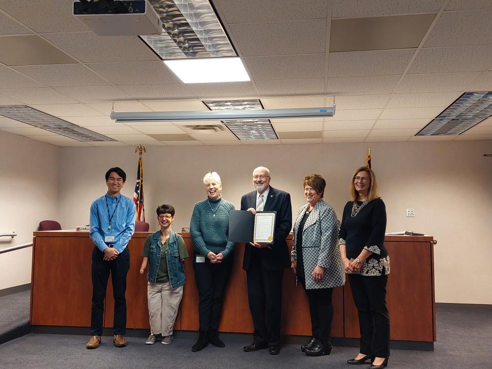 Commissioners Ron Amstutz (holding proclamation), Becky Foster and Sue Smail present a proclamation to OneEighty's Diversity Outreach Coordinator Yuta Nitanai (left to right); Gina Patterson, clinical director and Gayle Byrne, coordinated community response specialist, at Wednesday's Wayne County Commissioners meeting.