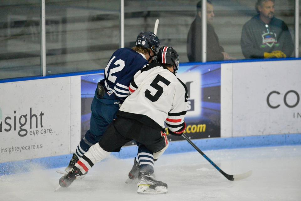 St. Cloud's Jaden Mendel collides with a Bemidji player on the boards against Bemidji at the MAC on Saturday, Nov. 27, 2021. 