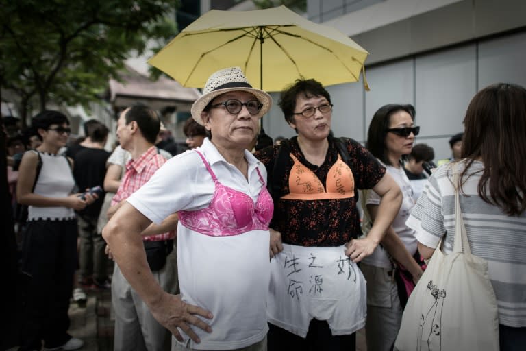 Protesters in bras demonstrate outside police headquarters in Hong Kong on August 2, 2015 in support of a woman who was sentenced to jail for assaulting a police officer with her breast