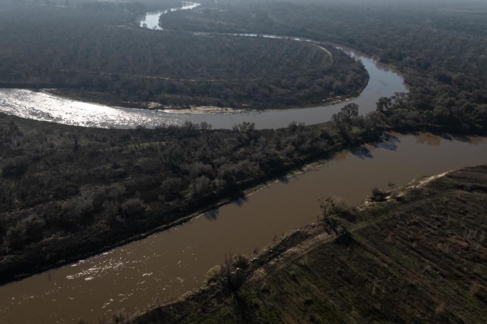 Sunshine glints off the surface of a river.