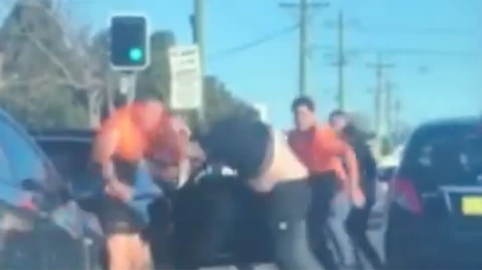 In peak hour traffic a verbal altercation quickly descended into an ugly brawl in front of shocked southwest Sydney commuters. Source: 7 News