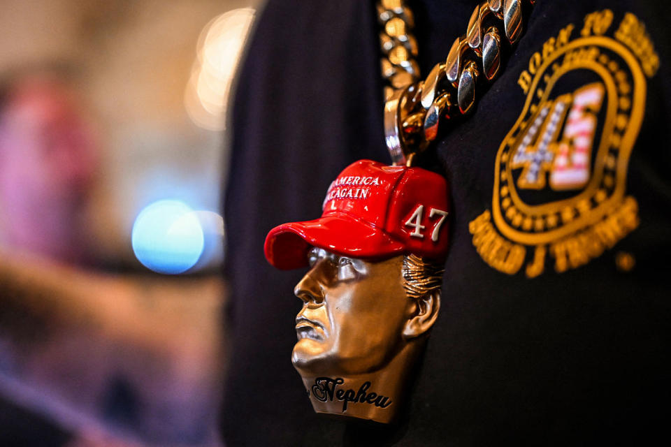 A supporter of Donald Trump wears a Trump bust jewelry. (Chandan Khanna / AFP - Getty Images)