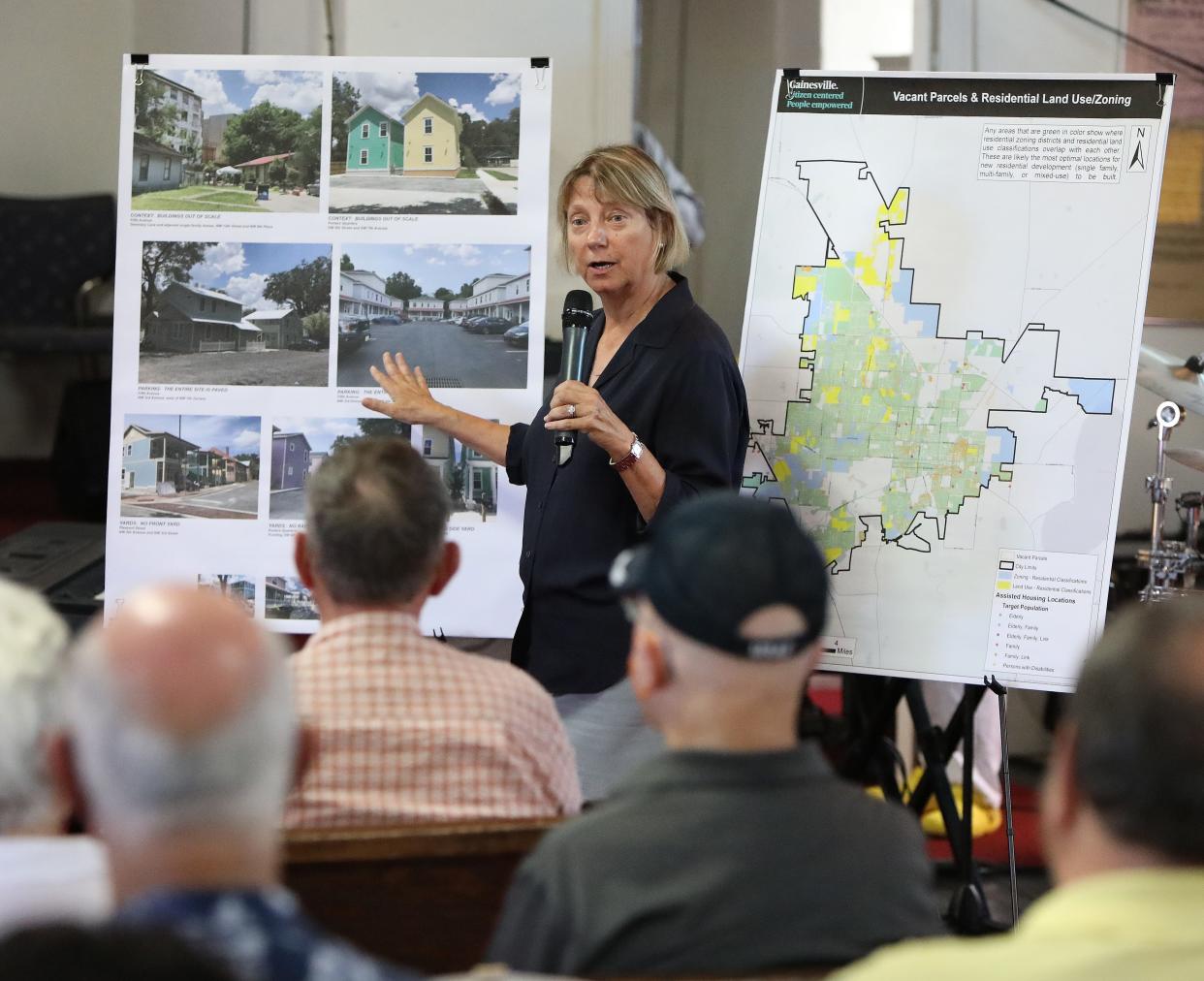 Kim Tanzer, a director of GNVoices, talks about some of the homes she has photographed where multi-family housing has moved in close to single-family housing near the Pleasant Street neighborhood, during a rally to stop the City of Gainesville from voting to allow multi-family housing throughout the city, at Shady Grove Primitive Baptist Church in the Porters Quarters, in Gainesville on Aug. 3, 2022.