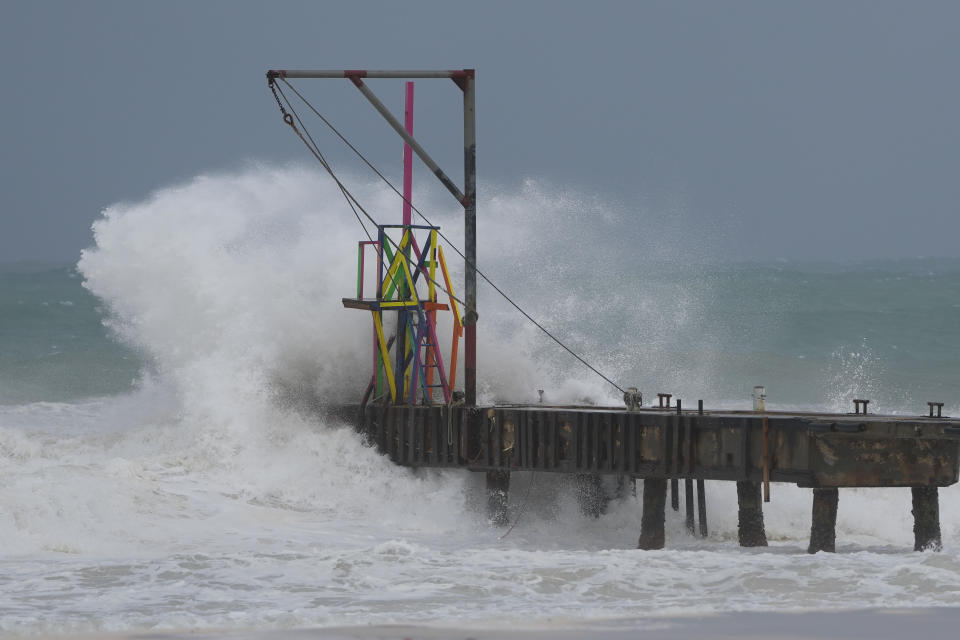 Waves from Hurricane Beryl batter a pier in Barbados.