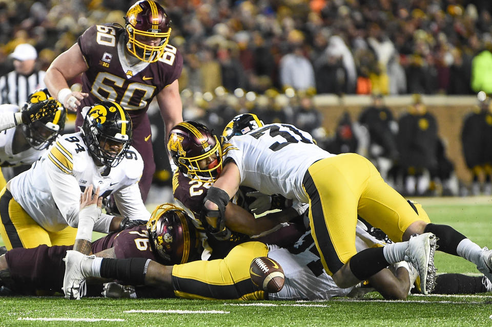 Minnesota running back Mohamed Ibrahim, second from right, fumbles the ball as he is hit by Iowa linebacker Jack Campbell (31) during the second half an NCAA college football game on Saturday, Nov. 19, 2022, in Minneapolis. The hit resulted in a turnover. (AP Photo/Craig Lassig)