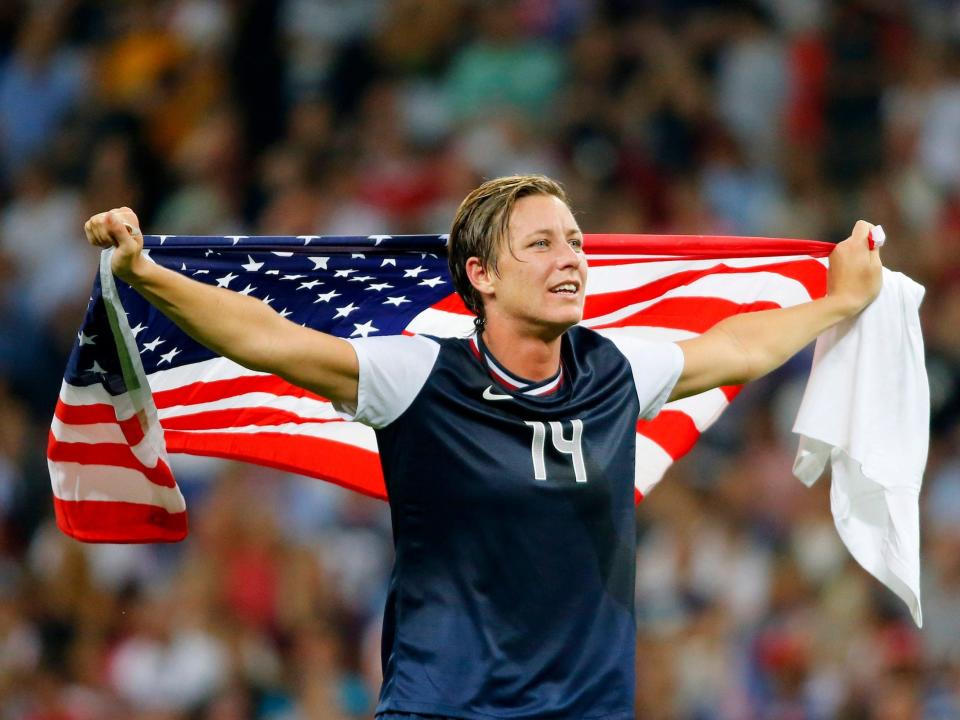 Abby Wambach celebrates after winning a gold medal with the USWNT at the 2012 Olympics.