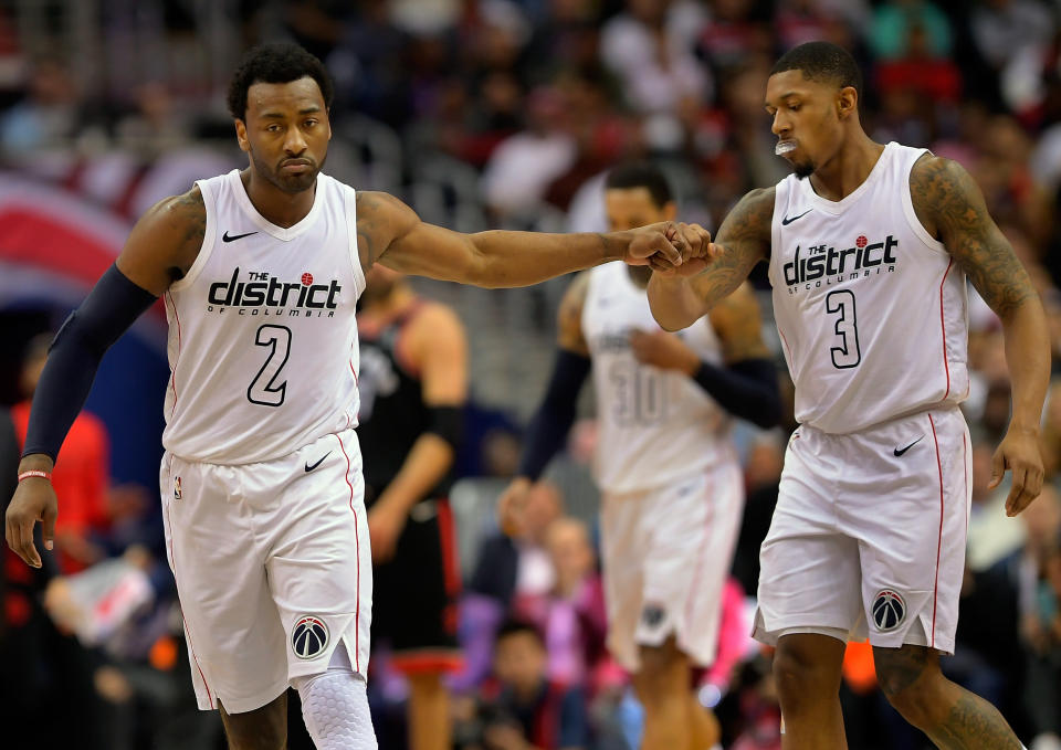 Washington guard John Wall, left, and guard Bradley Beal congratulate each other during the first half of game between the Toronto Raptors and the Wizards in 2018. 