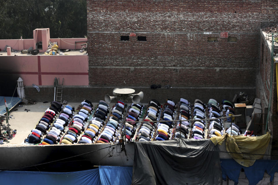 Muslims offer prayers on the roof of a fire-bombed mosque in New Delhi, India, Friday, Feb. 28, 2020. Muslims returned to the battle-torn streets of northeastern New Delhi for weekly prayers at heavily-policed fire-bombed mosques on Friday, two days after a 72-hour clash between Hindus and Muslims that left at least 38 dead and hundreds injured. (AP Photo/Altaf Qadri)