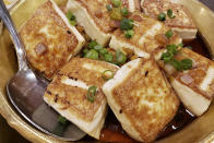 This Nov. 28, 2019, photo shows a plate of fried tofu served at a Chinese restaurant in New York City. A social media campaign backed by a Japanese seasonings company is targeting the persistent idea that Chinese food is packed with MSG and can make you sick. So entrenched is the notion in American culture, it shows up in the dictionary: Merriam-Webster.com lists “Chinese restaurant syndrome." as a real illness. But much of the mythology around the idea has been debunked: monosodium glutamate, also known as MSG, shows up in many foods from tomatoes to breast milk, and there's no evidence to link it to illness. (AP Photo/Wong Maye-E)