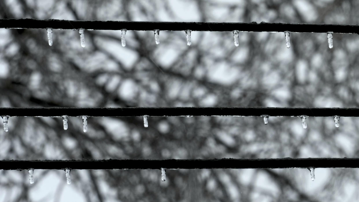 Ice forms on utility lines as temperatures hover around freezing in Detroit, Monday, Feb. 27, 2023. Some Michigan residents faced a fourth straight day without power as crews worked to restore electricity to more than 165,000 homes and businesses in the Detroit area after last week's ice storm. (AP Photo/Paul Sancya)